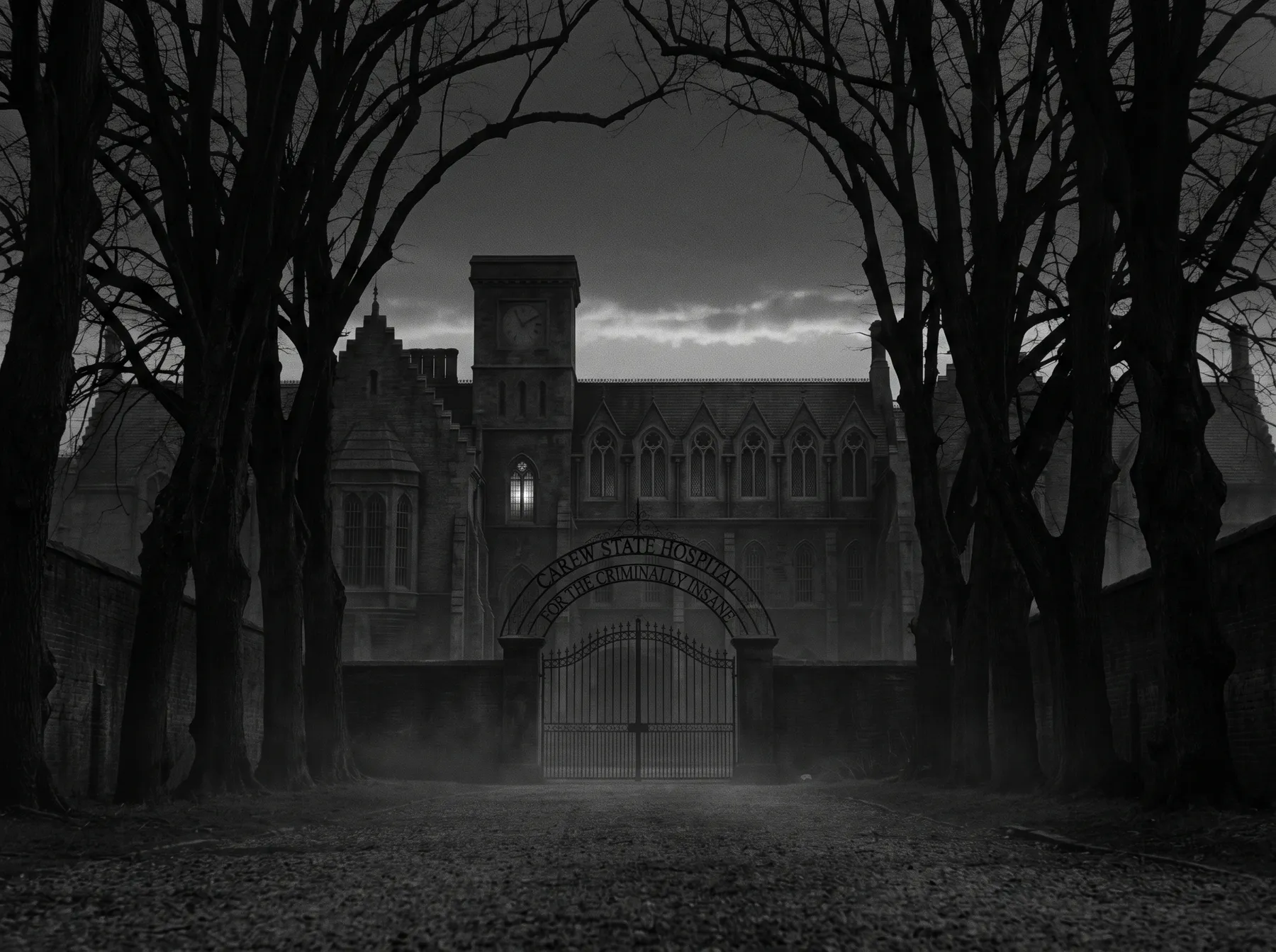 A black-and-white hospital exterior seen between bare trees