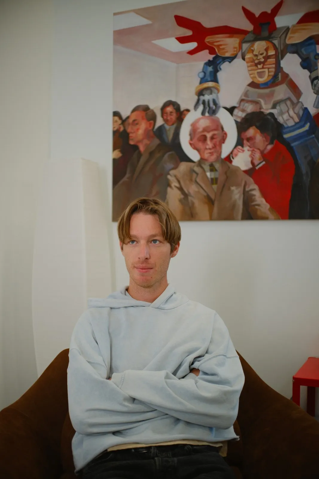 Devon Johns seated beneath a painting