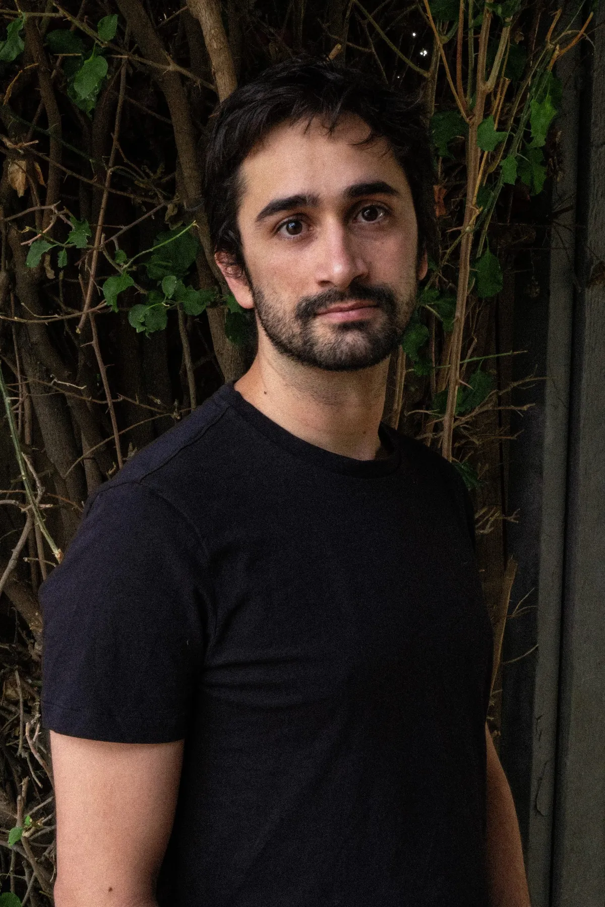 Pablo Cervera standing among climbing plants