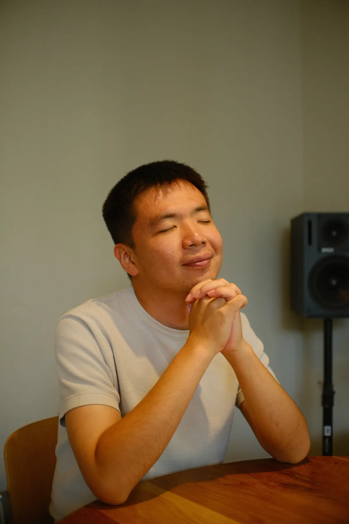 Robin Wang seated at a wooden table